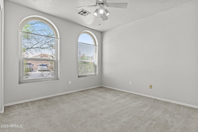 1135 W Sea Fog Dr, Gilbert, AZ 85233 - spare room featuring plenty of natural light, carpet floors, and a ceiling fan