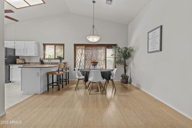 1135 W Sea Fog Dr, Gilbert, AZ 85233 - dining space with light wood-type flooring, high vaulted ceiling, and ceiling fan