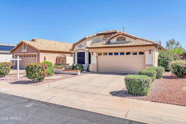 10745 W Beaubien Dr, Sun City, AZ 85373 - view of front facade featuring stucco siding, an attached garage, concrete driveway, and a tiled roof