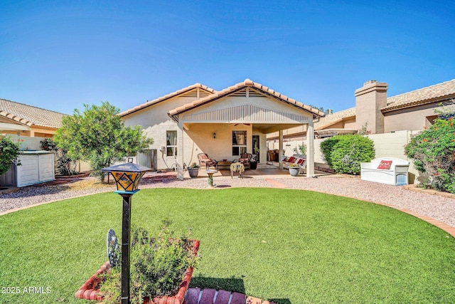 10745 W Beaubien Dr, Sun City, AZ 85373 - rear view of property with a ceiling fan, a fenced backyard, stucco siding, a patio area, and a lawn
