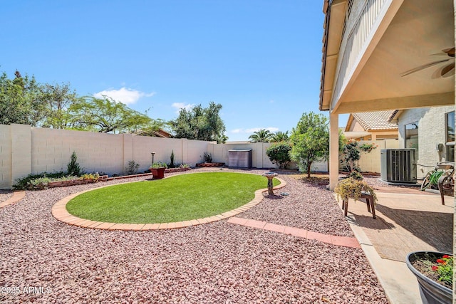 10745 W Beaubien Dr, Sun City, AZ 85373 - view of yard featuring a patio area, a fenced backyard, a ceiling fan, and cooling unit