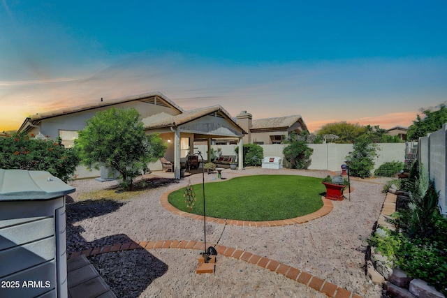 10745 W Beaubien Dr, Sun City, AZ 85373 - back of property with a patio area, a fenced backyard, a yard, and stucco siding