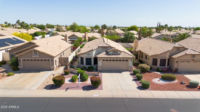 10745 W Beaubien Dr, Sun City, AZ 85373 - view of front of property featuring driveway, a residential view, and stucco siding