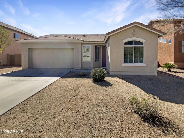 single story home with an attached garage, a tile roof, concrete driveway, and stucco siding