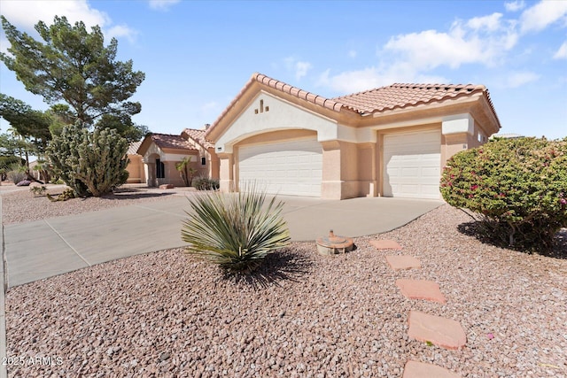 mediterranean / spanish-style house with stucco siding, an attached garage, driveway, and a tiled roof