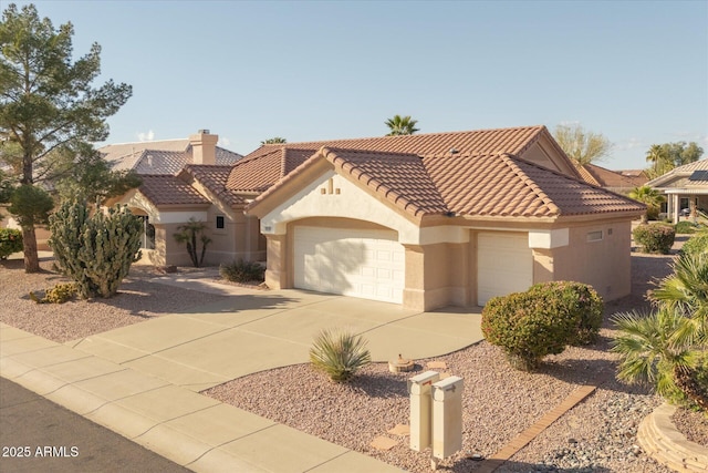 mediterranean / spanish home with stucco siding, a garage, driveway, and a tile roof