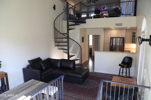 5720 S 21st Ter, Phoenix, AZ 85040 - living room with a towering ceiling, stairs, a ceiling fan, and baseboards