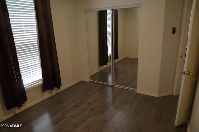 5720 S 21st Ter, Phoenix, AZ 85040 - unfurnished bedroom with a closet, wood finished floors, and baseboards
