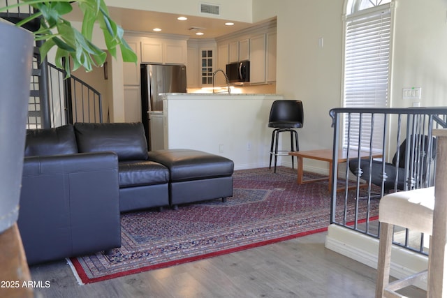 5720 S 21st Ter, Phoenix, AZ 85040 - living room featuring wood finished floors, baseboards, and recessed lighting