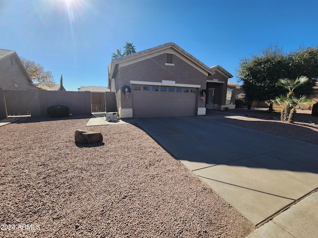 view of front of property featuring cooling unit and a garage