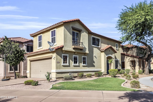 mediterranean / spanish house with a front lawn and a garage