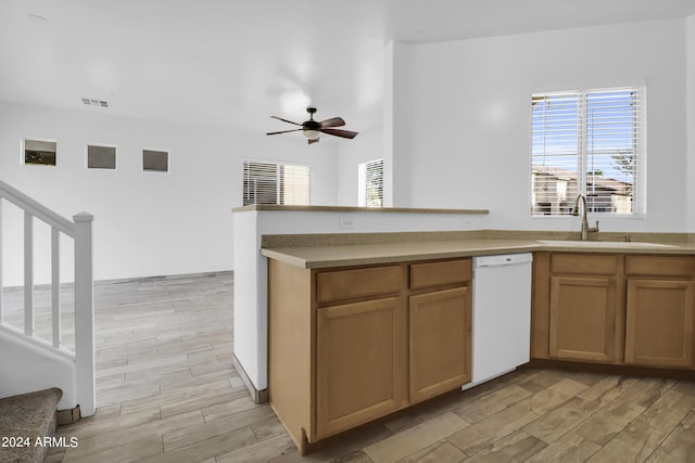 kitchen featuring ceiling fan, white dishwasher, and sink