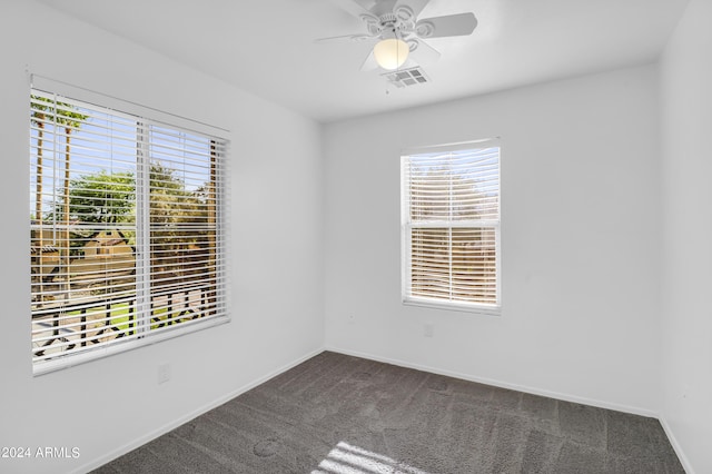 carpeted spare room with ceiling fan