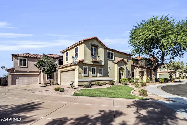 mediterranean / spanish home with a front lawn and a garage