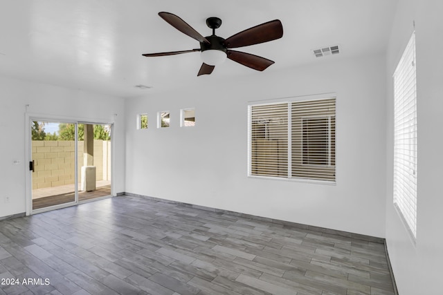 empty room featuring ceiling fan and light hardwood / wood-style floors