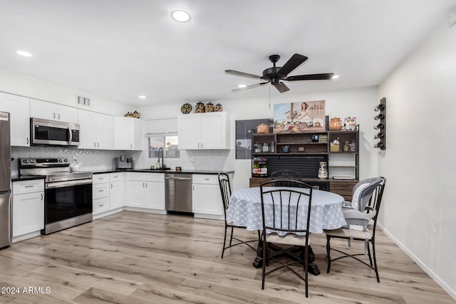 kitchen featuring light hardwood / wood-style flooring, white cabinets, and stainless steel appliances