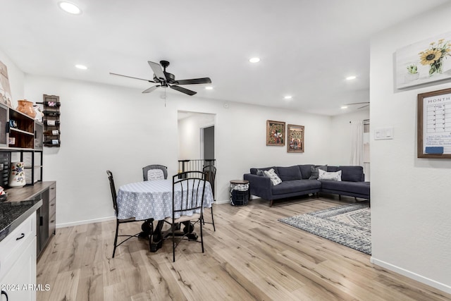 dining space featuring ceiling fan and light wood-type flooring