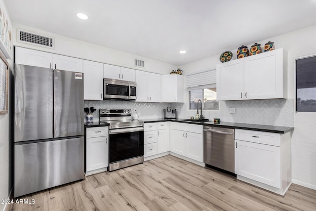 kitchen featuring white cabinetry, light hardwood / wood-style flooring, stainless steel appliances, and sink