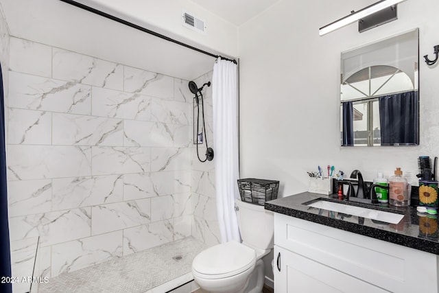 bathroom with vanity, curtained shower, and toilet