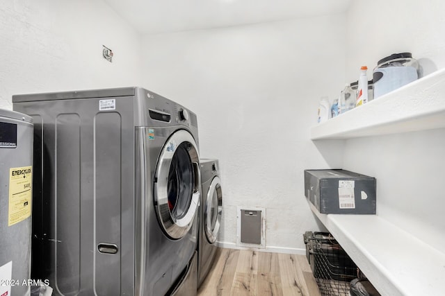 laundry room featuring washer and dryer and light wood-type flooring