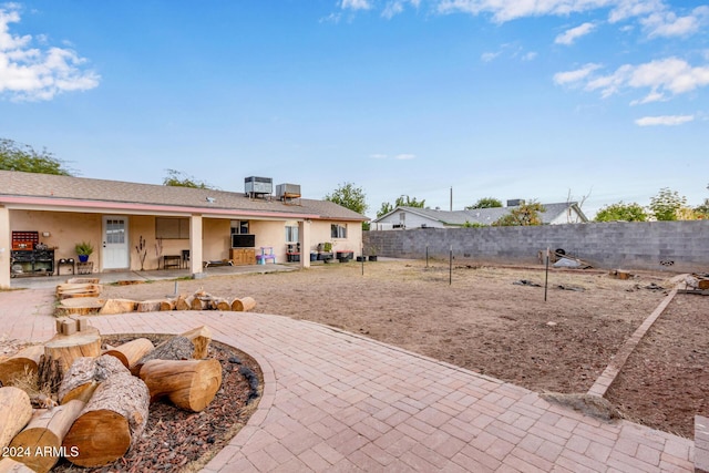 rear view of property with a patio area and cooling unit