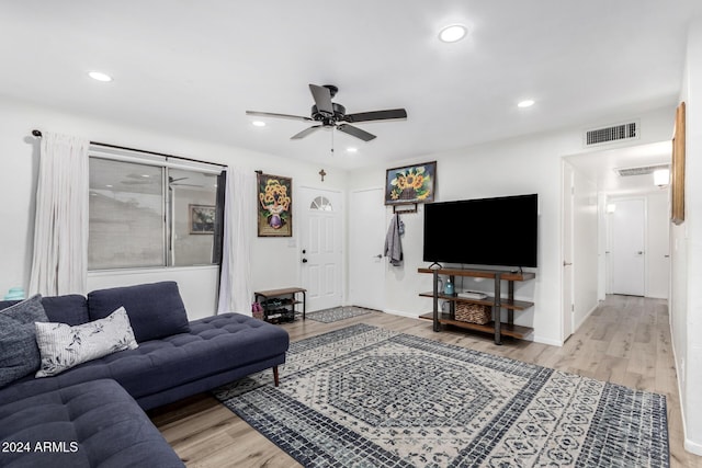 living room featuring light hardwood / wood-style floors and ceiling fan