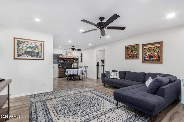 living room with ceiling fan and hardwood / wood-style flooring