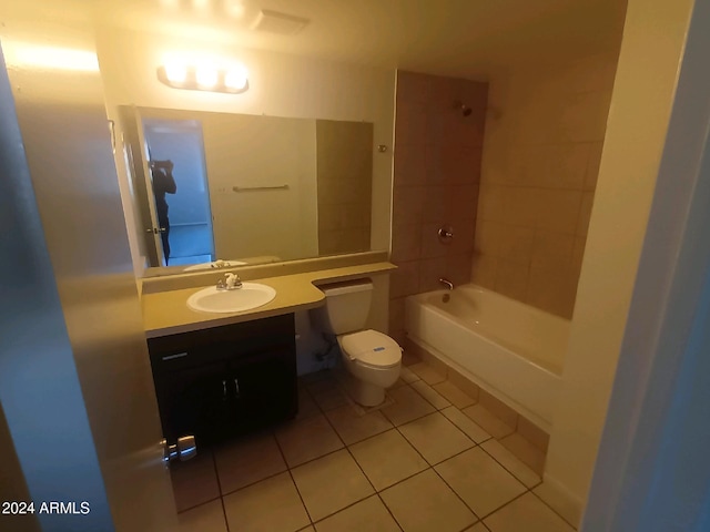 full bathroom with tiled shower / bath, vanity, toilet, and tile patterned flooring