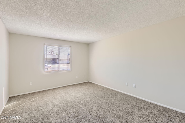 unfurnished room featuring carpet floors and a textured ceiling