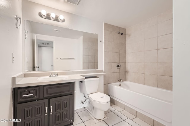 full bathroom with vanity, toilet, tile patterned flooring, and tiled shower / bath