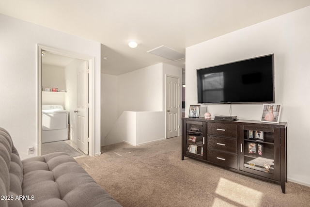 living room with light carpet and washer / clothes dryer