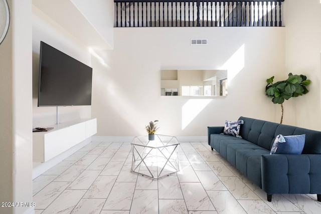 living room with a towering ceiling