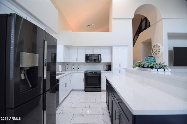 kitchen featuring kitchen peninsula, decorative backsplash, black appliances, high vaulted ceiling, and white cabinetry