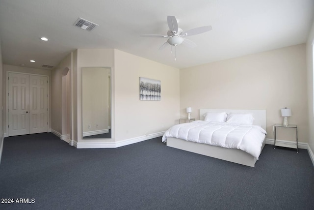 bedroom featuring ceiling fan and dark carpet