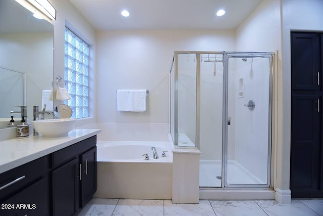 bathroom featuring vanity and separate shower and tub