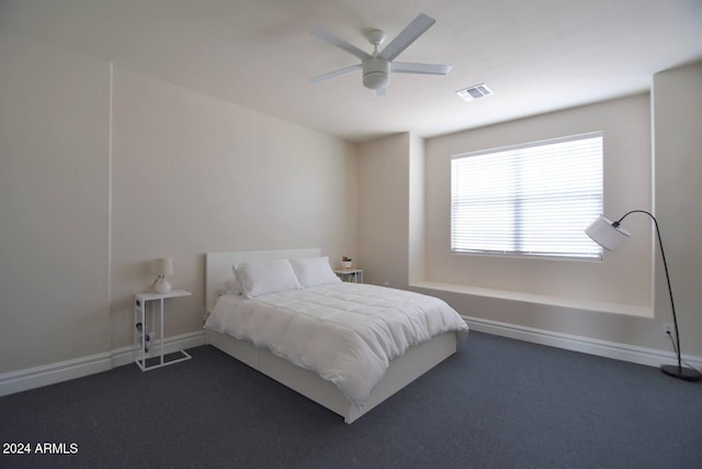 bedroom with dark colored carpet and ceiling fan