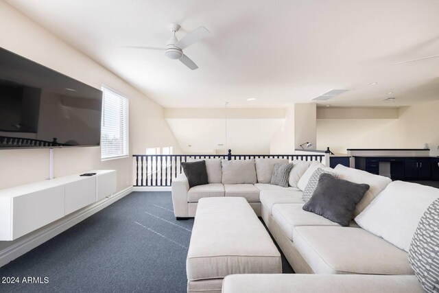 carpeted living room with ceiling fan