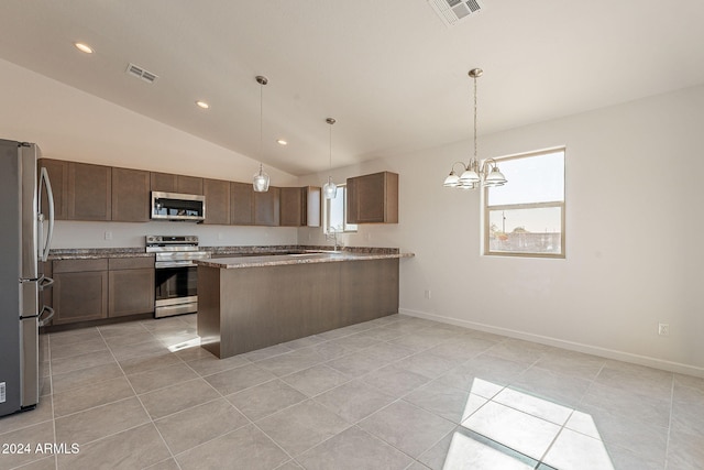 kitchen with hanging light fixtures, stainless steel appliances, kitchen peninsula, vaulted ceiling, and light tile patterned floors