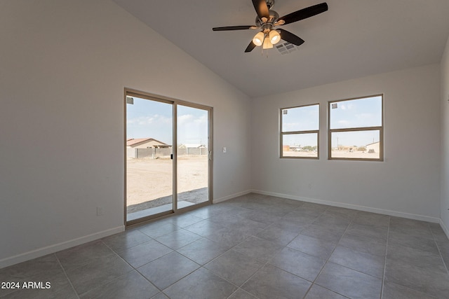 spare room with tile patterned flooring, ceiling fan, and vaulted ceiling