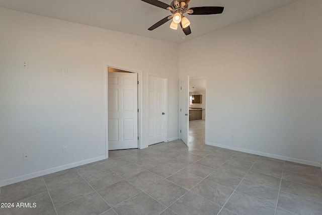 unfurnished bedroom featuring ceiling fan and light tile patterned floors