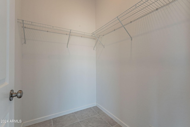 spacious closet featuring light tile patterned floors