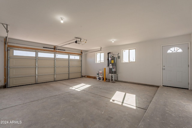 garage featuring a garage door opener and water heater