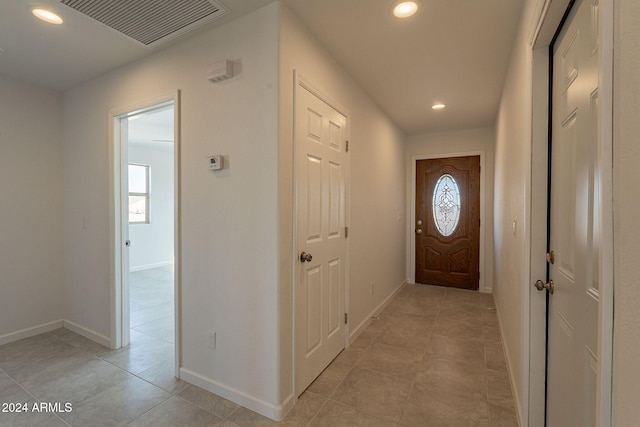 doorway featuring light tile patterned flooring