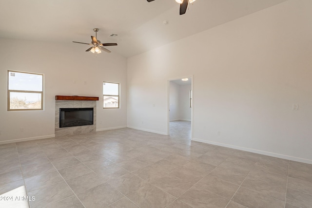 unfurnished living room with light tile patterned floors, high vaulted ceiling, and ceiling fan