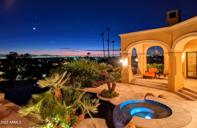 patio terrace at dusk with an in ground hot tub