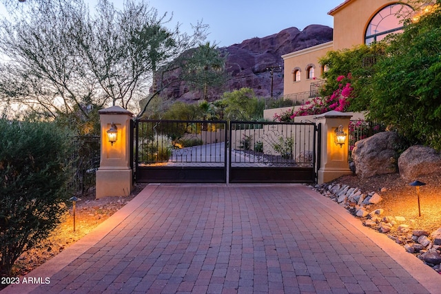 gate at dusk with a mountain view