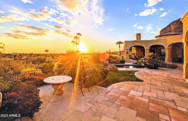 view of patio terrace at dusk