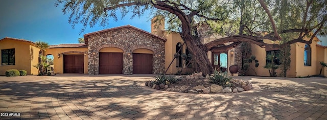 mediterranean / spanish-style house with a garage