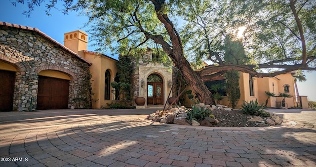 view of front of property with french doors and a garage