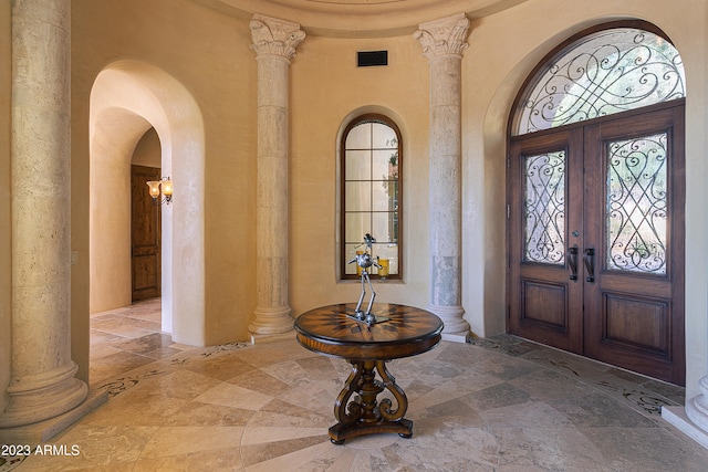 entryway with ornate columns and french doors